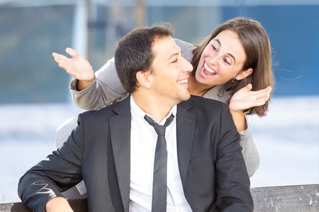 Playful Business Woman Uncovering Colleague Eyesの写真素材