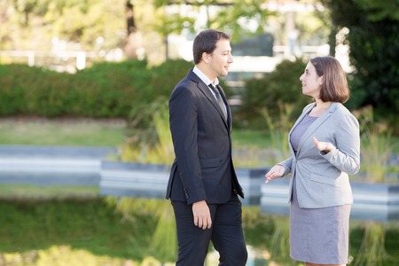Relaxed Business Man and Woman Chatting in Parkの写真素材