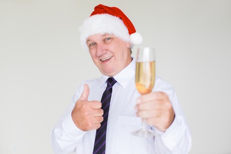 Happy Business Man in Santa Hat with Champagneの写真素材