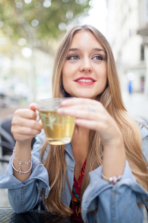 Smiling Young Beautiful Woman in Outdoor Cafeの写真素材