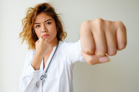 Portrait of angry general practitioner boxingの写真素材