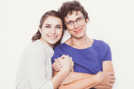 Smiling young woman embracing senior motherの写真素材