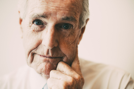 Pensive senior businessman staring at cameraの写真素材