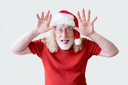 Joyful Man in Christmas Hat Teasing at Cameraの写真素材