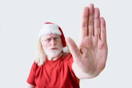 Strict Senior Man in Santa Hat with Stop Gestureの写真素材