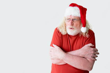 Santa Claus in t-shirt shivering with coldの写真素材