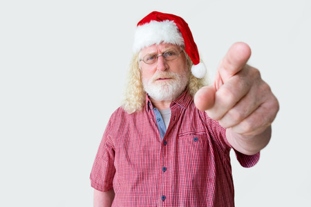 Senior man in Santa Claus hat pointing at youの写真素材