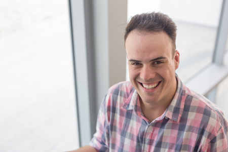 Smiling face of young man looking at cameraの写真素材