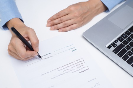 Accounting manager filling document at table