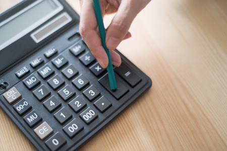 Closeup of Accountant Using Calculatorの写真素材