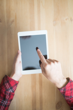 Closeup of Person Networking on Tablet at Tableの写真素材