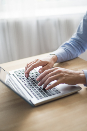 Closeup of Person Working on Laptop in Office