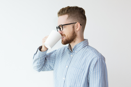 Happy Man Drinking from White Cup and Smilingの写真素材