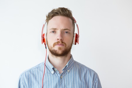 Portrait of Tired Young Man in Headphoneの写真素材