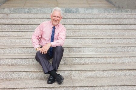 Relaxed Entrepreneur Sitting on Stairs Outdoorsの写真素材