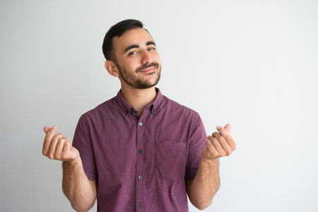 Content Man Rubbing Fingers and Asking for Moneyの写真素材