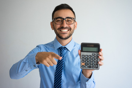 Smiling Business Man Showing Calculatorの写真素材