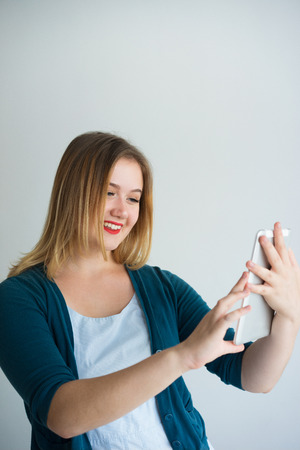 Happy beautiful girl talking via video conferenceの写真素材