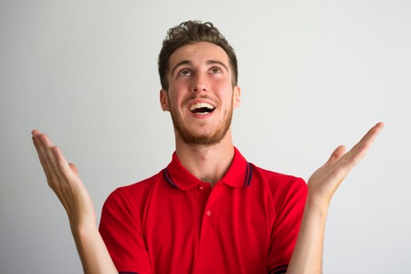 Portrait of happy young man asking for god mercyの写真素材