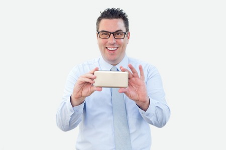 Smiling Business Man Showing Smartphoneの写真素材