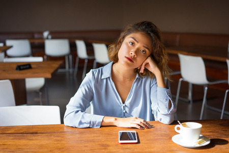 Pensive Young Business Woman on her Coffee Breakの写真素材