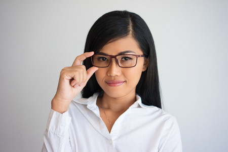 Content Nice Asian Business Lady Adjusting Glassesの写真素材