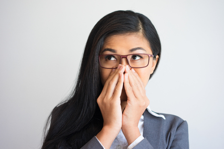 Excited Beautiful Business Woman Covering Mouthの写真素材