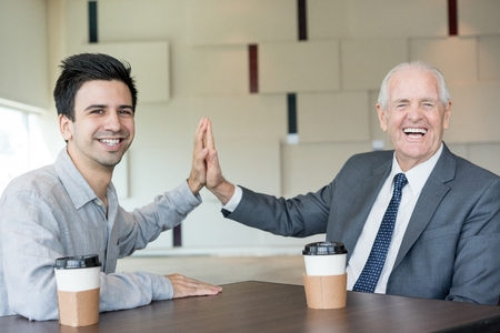 Positive successful businessmen giving fiveの写真素材