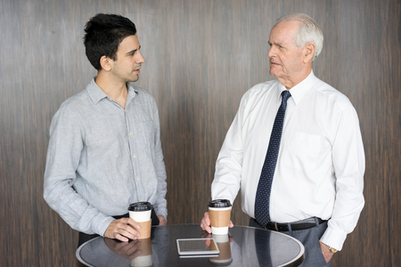 Two Serious Businessmen Arguing at Office Cafeの写真素材