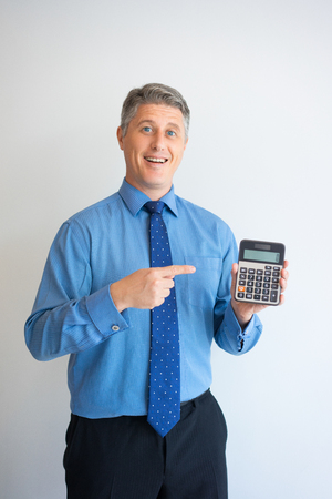 Happy businessman showing calculatorの写真素材