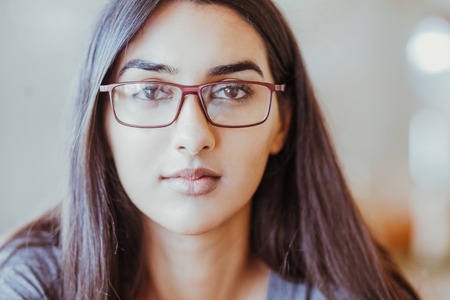 Serious intelligent female student in eyeglassesの写真素材