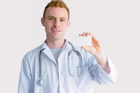 Friendly Caucasian Male Doctor Showing Badgeの写真素材