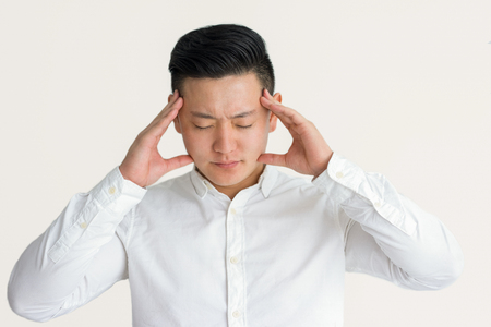 Exhausted businessman suffering from headacheの写真素材