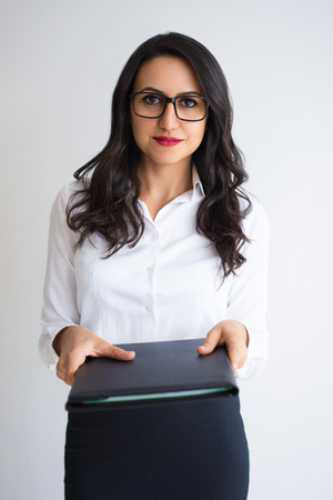 Serious Woman Giving Folder with Documentsの写真素材