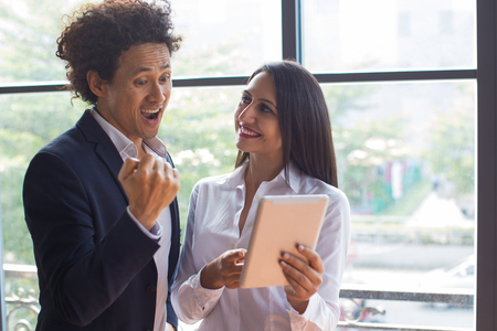 Excited man pleasantly surprised with forecastの写真素材