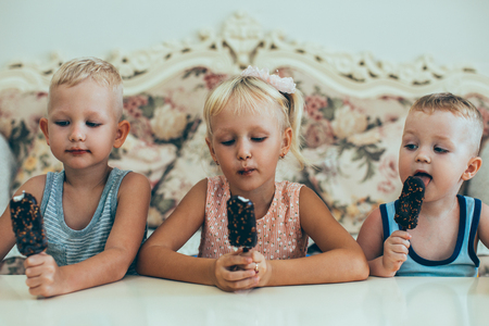 Little Boys and Girl Eating Ice-Cream at Homeの写真素材
