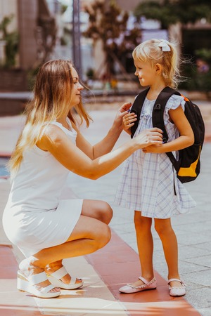 Mother Adjusting Daughter Clothes Before Schoolの写真素材