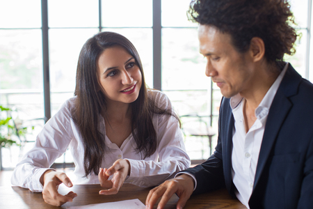 Smiling woman asking business partner for adviceの写真素材