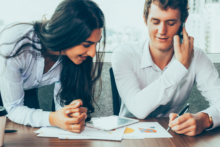 Confident male colleague negotiating on phoneの写真素材