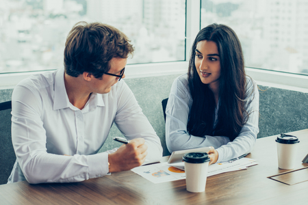 Interracial business partners discussing dealの写真素材