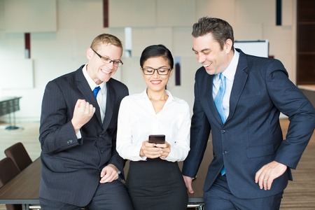 Happy colleagues rejoicing successful negotiationsの写真素材