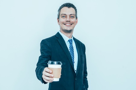 Happy Business Man Giving Drink in Disposable Cupの写真素材