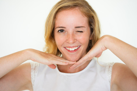 Closeup of Smiling Cute Woman Winking and Posingの写真素材
