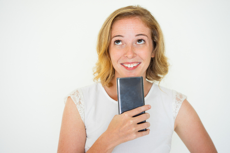 Dreamy Pretty Woman Holding Smartphoneの写真素材