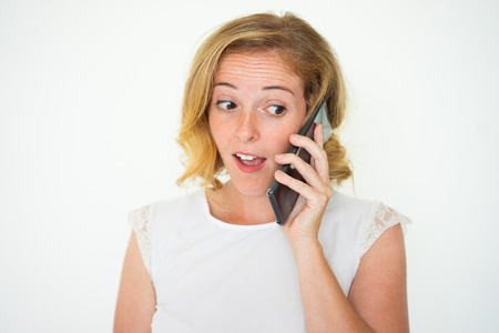 Surprised Pretty Woman Talking on Smartphoneの写真素材