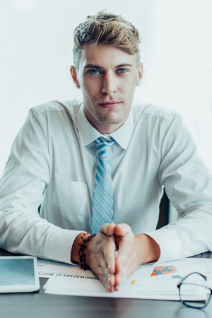 Serious Business Man Sitting at Office Deskの写真素材