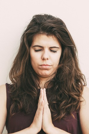 Calm Young Woman Meditating with Eyes Closed