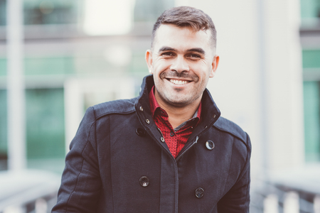 Portrait of happy young fashionable man outdoorsの写真素材