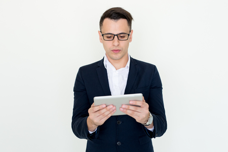 Serious Attractive Business Man Using Tabletの写真素材
