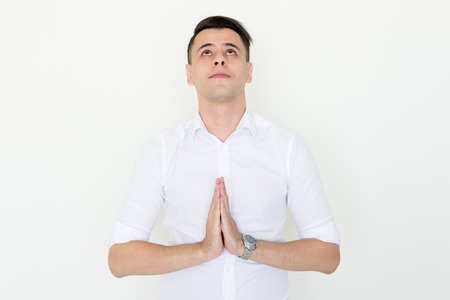 Serious Man Keeping Hands Together and Prayingの写真素材